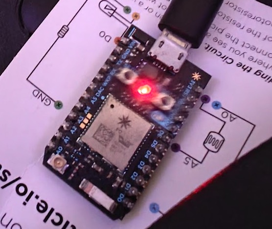 Particle Photon going red. The getting-started guide doubles as a shelf.